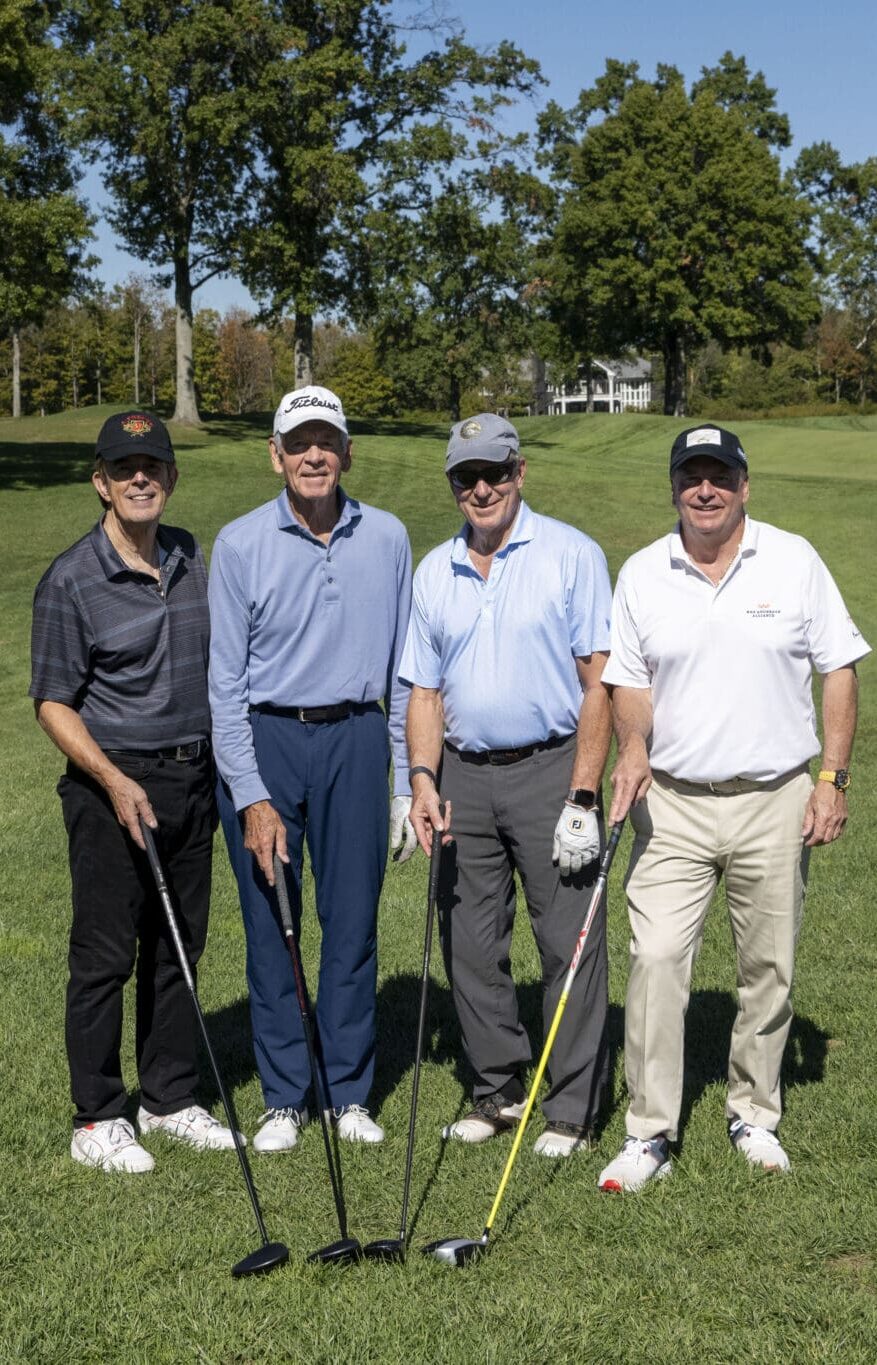 A foursome of golfers together on the course at the KAA Golf Classic